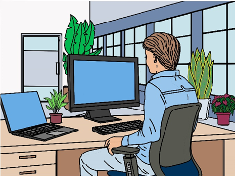 eine Person sitzt am Computerarbeitsplatz